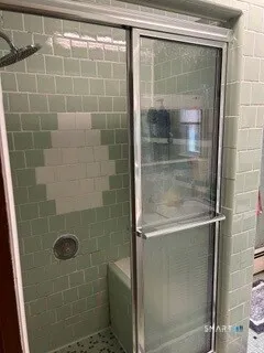 a bathroom with a glass shower door