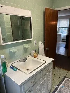 a bathroom with a sink a toilet and mirror