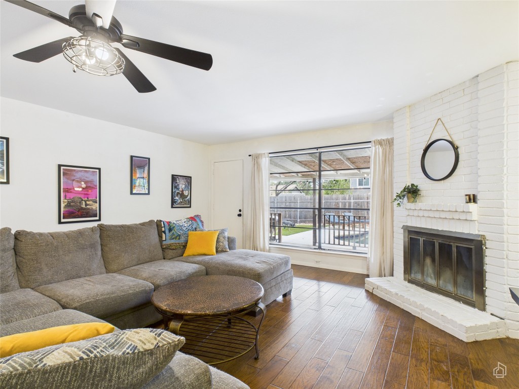 1404 Lance Way Austin, TX 78758 - Photo 12 of 29 a living room with furniture a fireplace and a floor to ceiling window