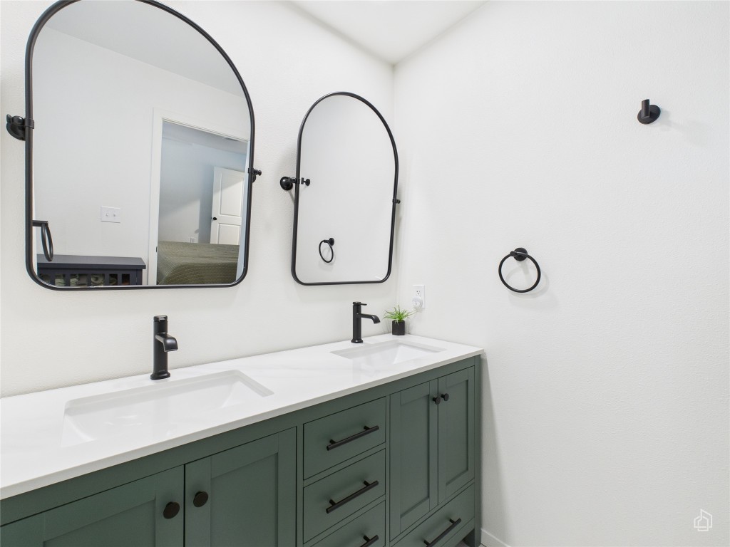 1404 Lance Way Austin, TX 78758 - Photo 18 of 29 a bathroom with a double vanity sink and a mirror
