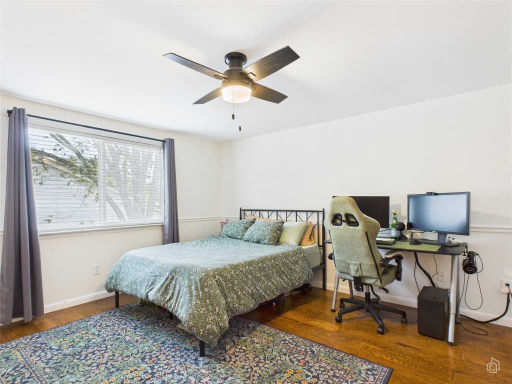 1404 Lance Way Austin, TX 78758 - Photo 20 of 29 a bedroom with a bed and a chandelier