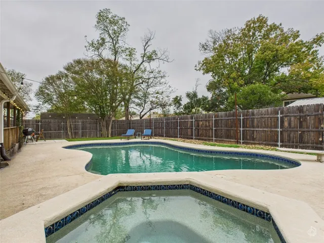 a view of a backyard with swimming pool