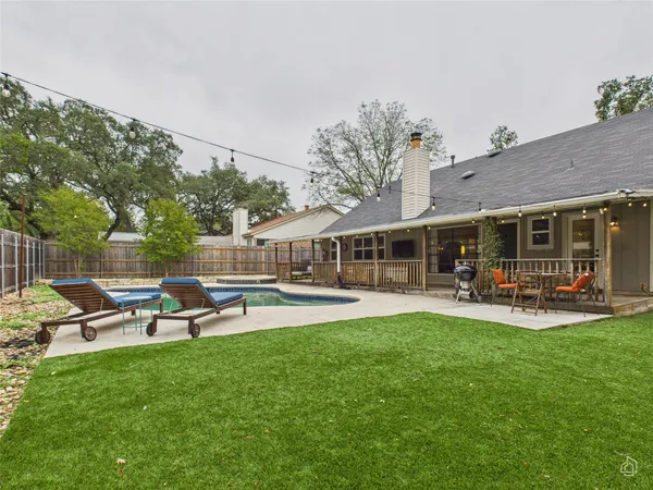 a view of a house with backyard and sitting area