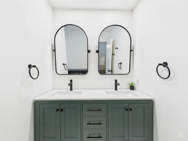 a bathroom with 2 sink and a mirror