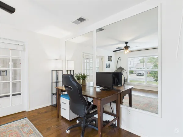a view of a workspace with furniture and a window