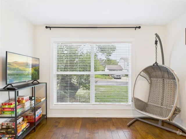 a view of a livingroom with wooden floor and a flat screen tv