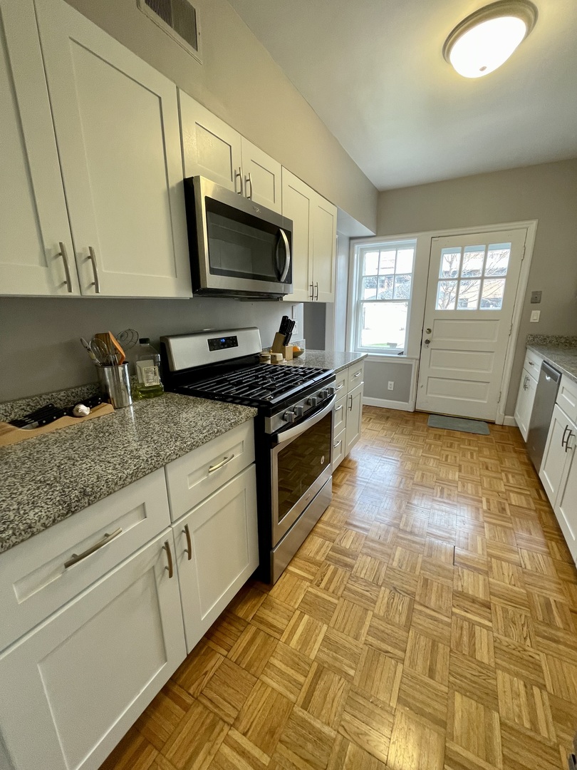 1035 Bonnie Brae River Forest, IL 60305 - Photo 11 of 21 a kitchen with granite countertop a sink and a stove top oven