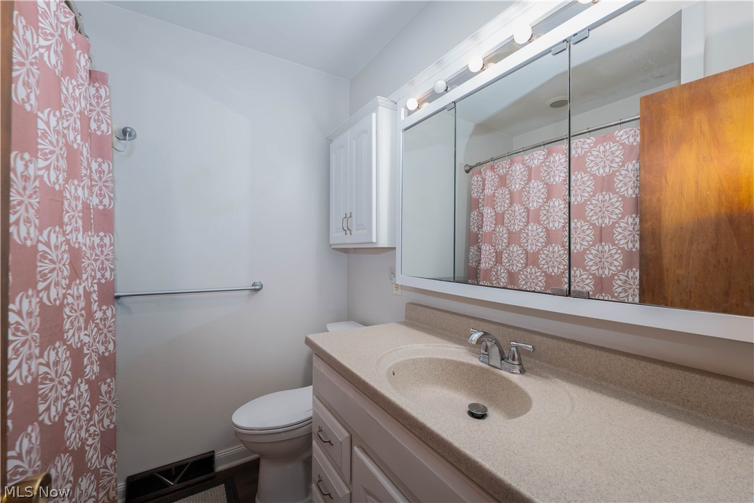 1619 Reed Street Canal Fulton, OH 44614 - Photo 15 of 27 Vanity with integrated sink, chrome faucet, and mirrored medicine cabinet