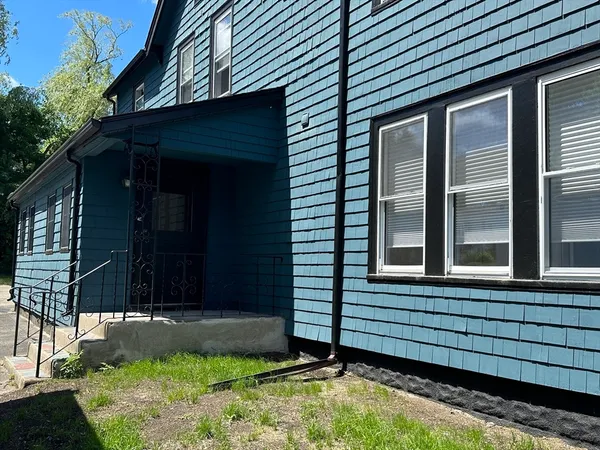 a view of house with backyard