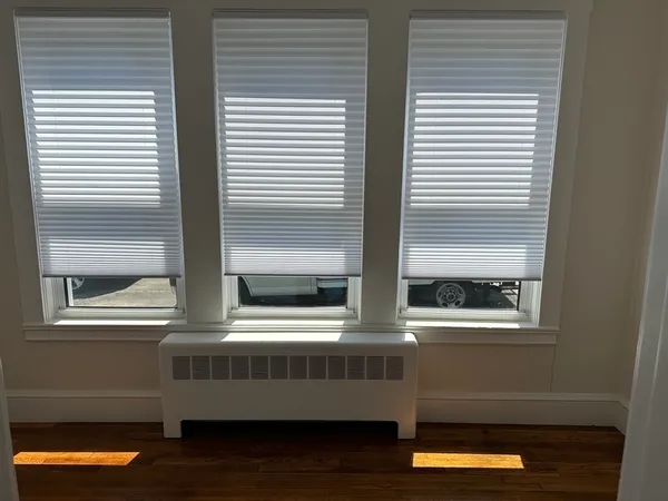 a room with wooden floor and a window