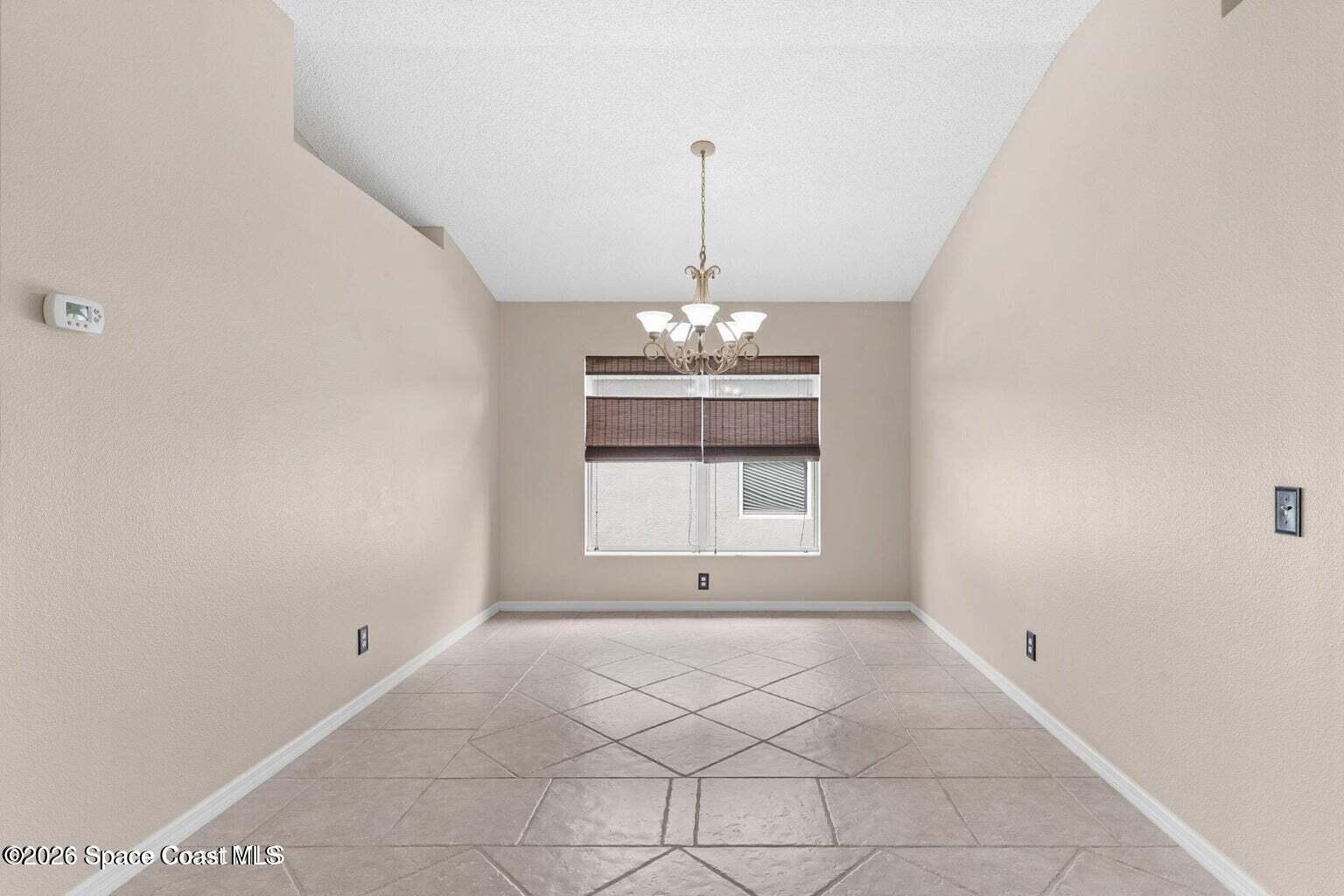 4741 Decatur Circle Melbourne, FL 32934 - Photo 7 of 44 a view of an empty room with a window