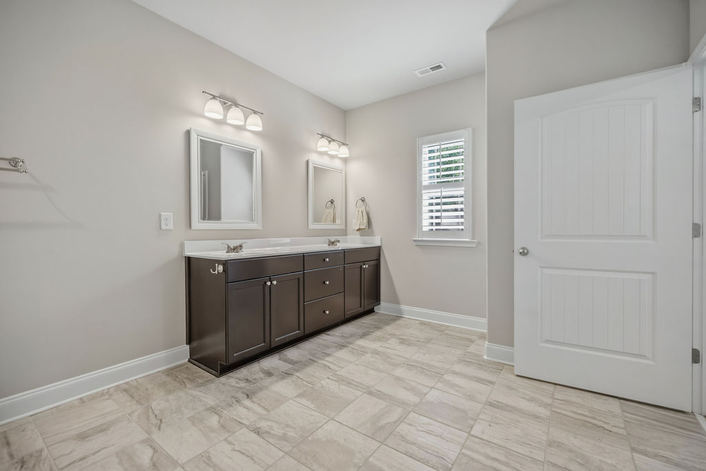 139 Olde Towne Drive Anderson, SC 29621 - Photo 14 of 26 This spacious bathroom offers a double vanity and elegant tile flooring, creating a refreshing atmosphere.
