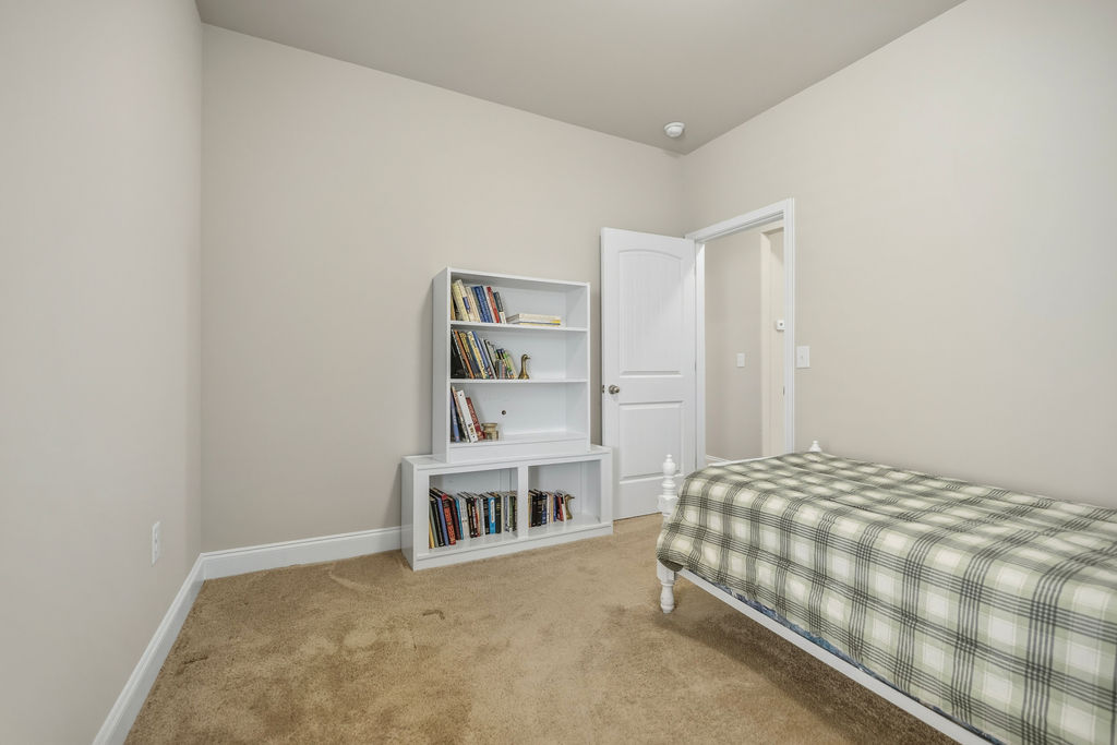139 Olde Towne Drive Anderson, SC 29621 - Photo 16 of 26 This cozy bedroom features warm neutral tones and a functional built-in bookshelf for organized living.