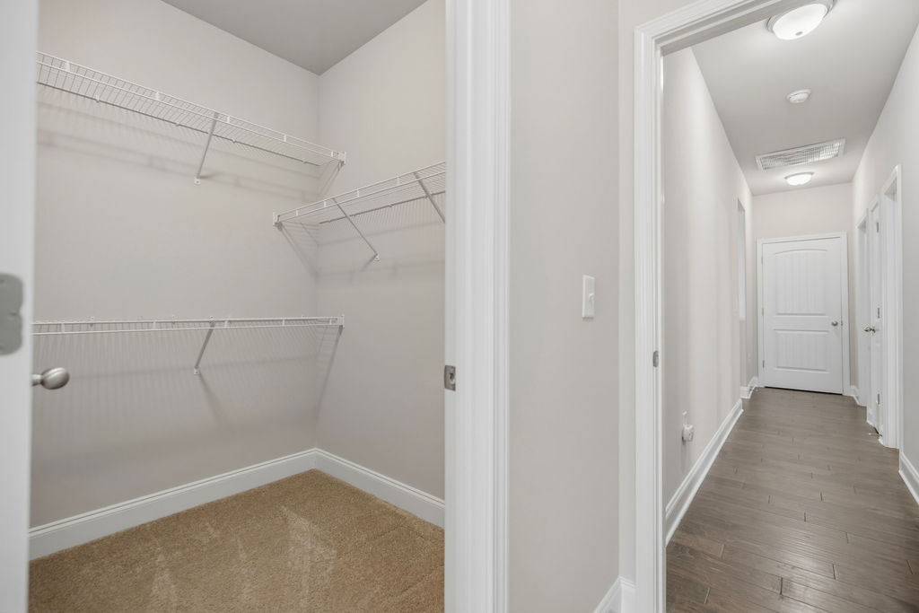 139 Olde Towne Drive Anderson, SC 29621 - Photo 21 of 26 This spacious walk-in closet offers ample storage, while a bright hallway features elegant wood flooring.