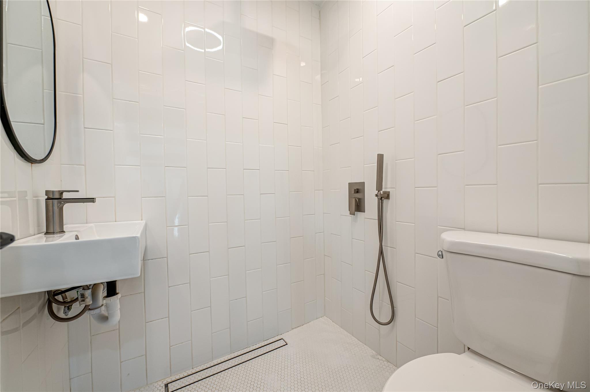 39 Lynncliff Road Hampton Bays, NY 11946 - Photo 13 of 34 Bathroom with tile walls and a tile shower