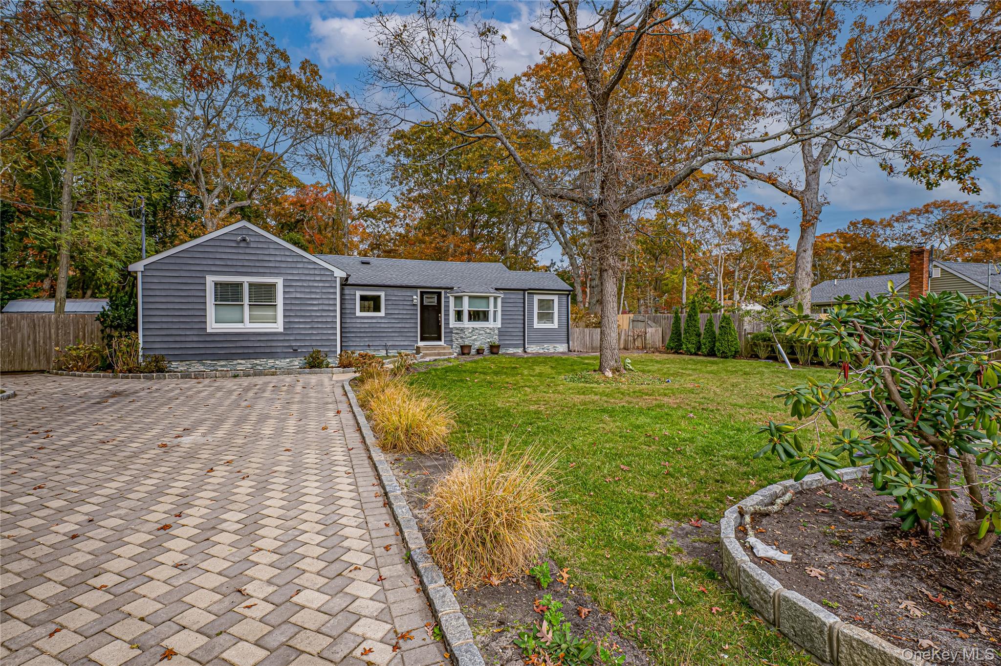 39 Lynncliff Road Hampton Bays, NY 11946 - Photo 2 of 34 View of front facade featuring view of scattered trees
