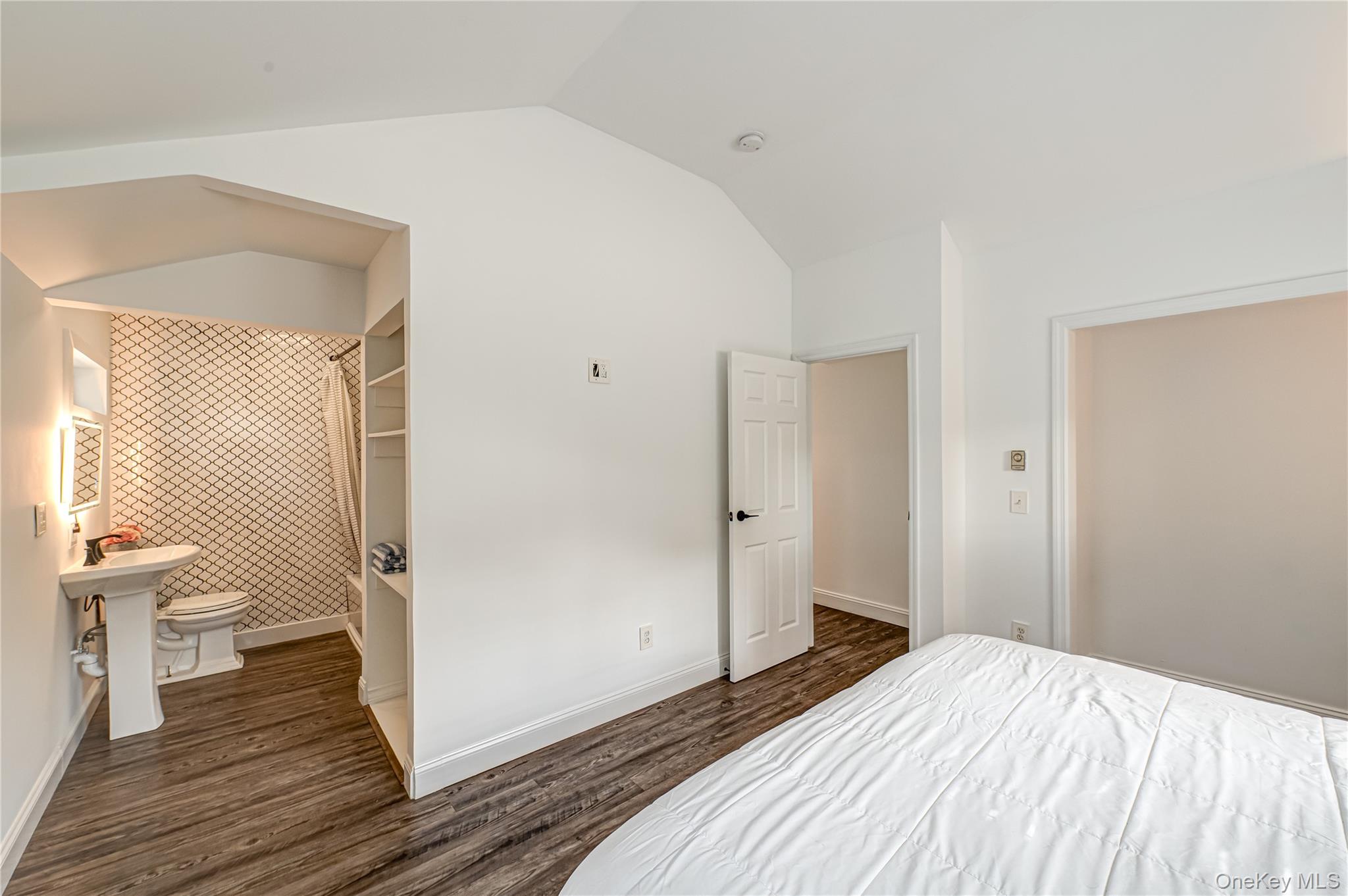 39 Lynncliff Road Hampton Bays, NY 11946 - Photo 19 of 34 Bedroom featuring lofted ceiling, dark wood finished floors, and connected bathroom