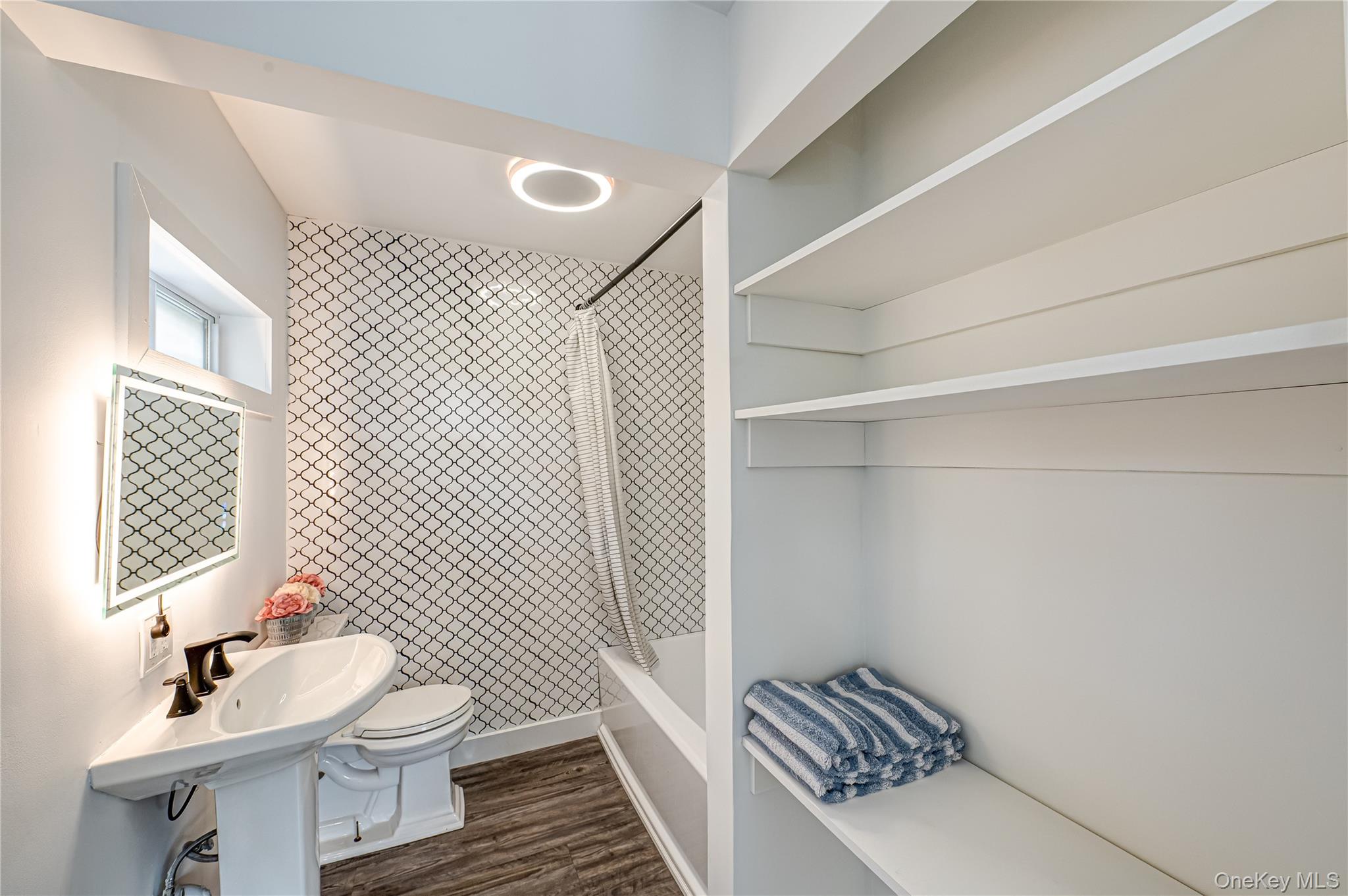 39 Lynncliff Road Hampton Bays, NY 11946 - Photo 20 of 34 Bathroom featuring bathing tub / shower combination and dark wood-style floors