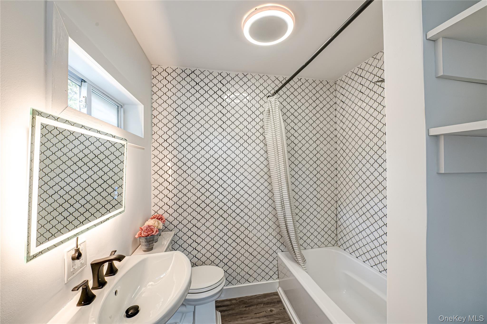 39 Lynncliff Road Hampton Bays, NY 11946 - Photo 21 of 34 Full bathroom featuring bathtub / shower combination and wood finished floors
