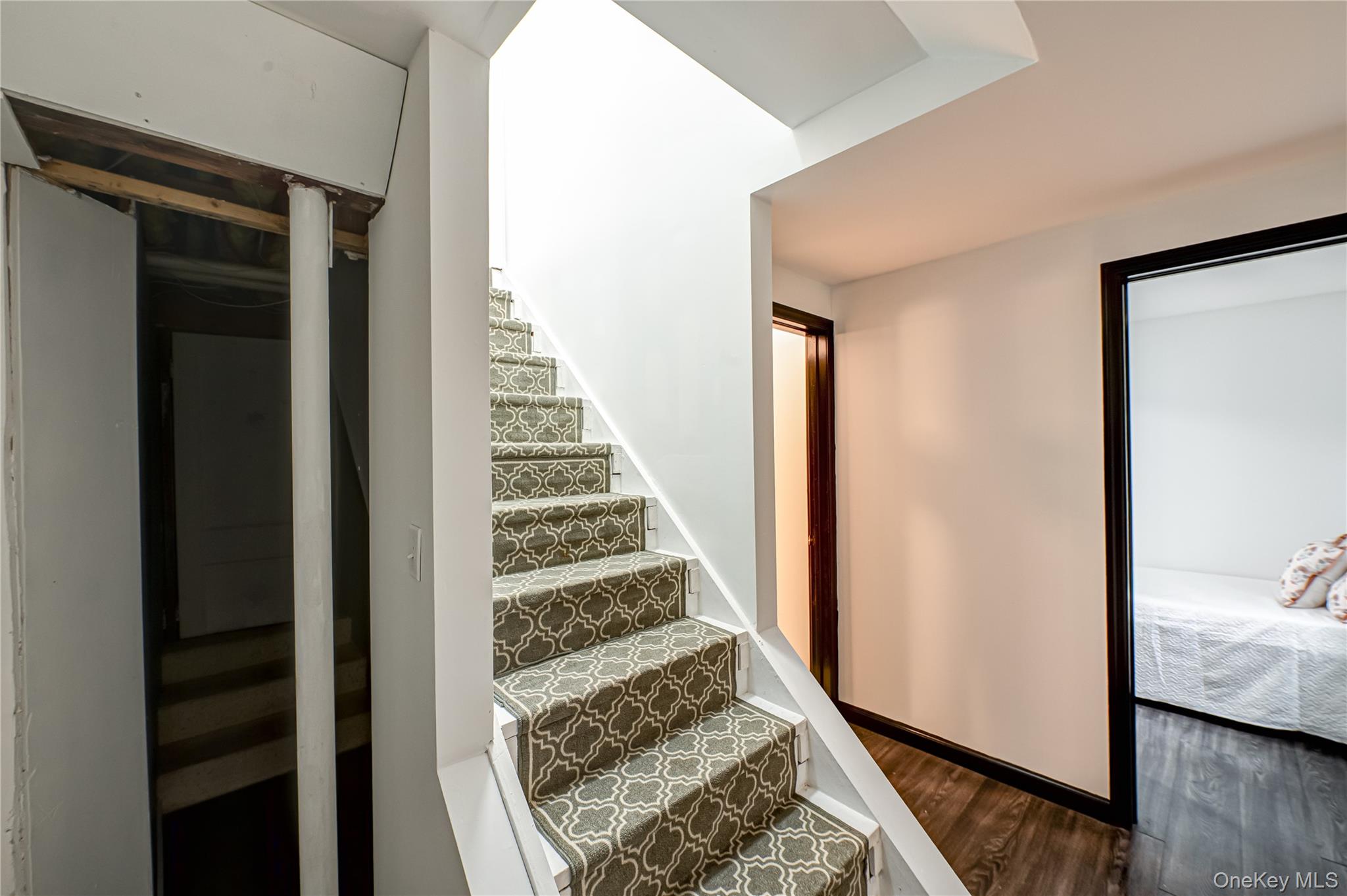39 Lynncliff Road Hampton Bays, NY 11946 - Photo 22 of 34 Stairs featuring wood finished floors and baseboards