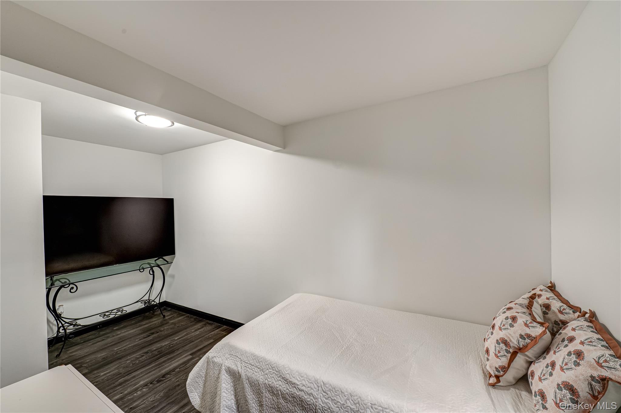 39 Lynncliff Road Hampton Bays, NY 11946 - Photo 23 of 34 Bedroom with dark wood-type flooring and baseboards