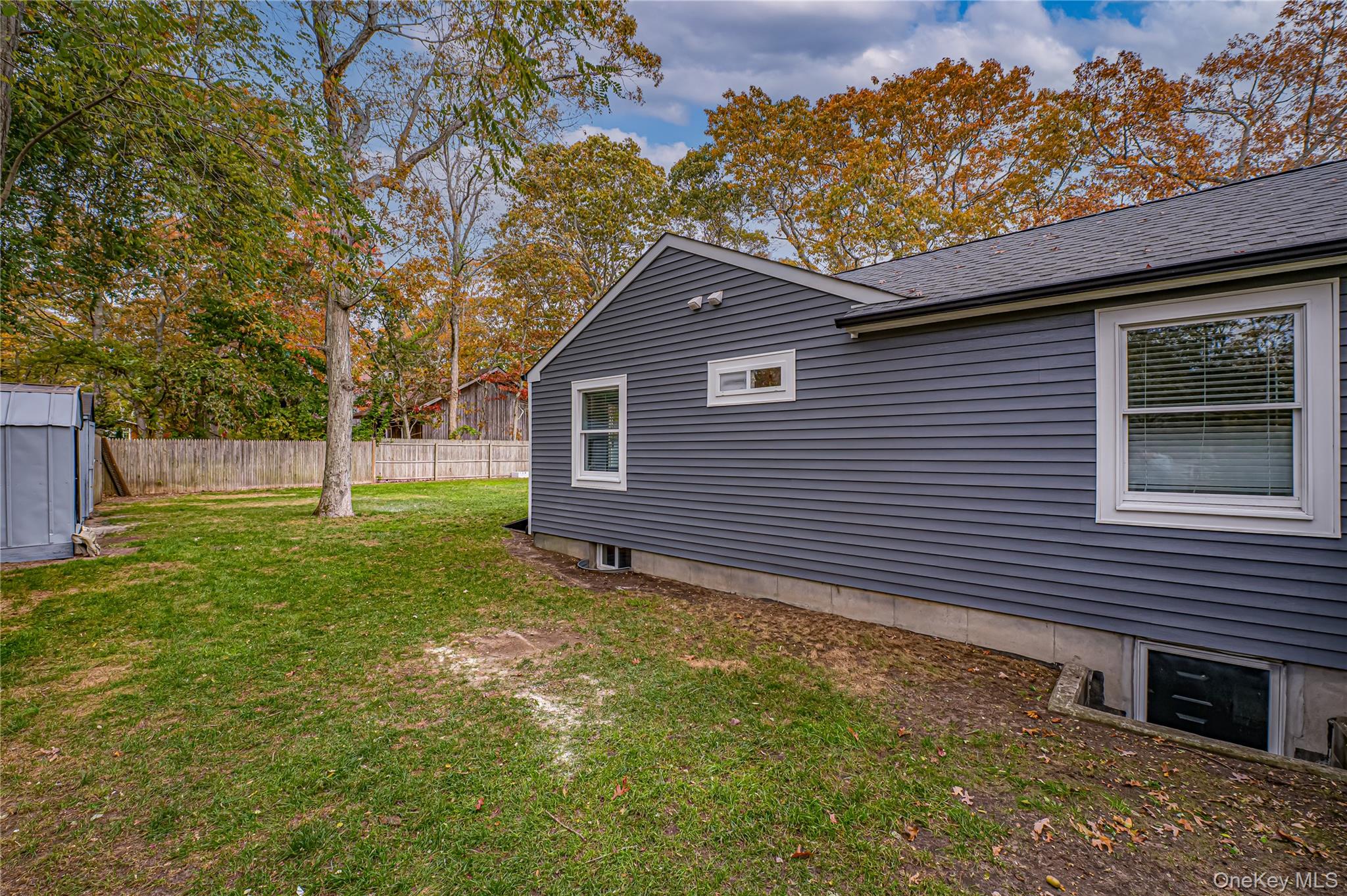 39 Lynncliff Road Hampton Bays, NY 11946 - Photo 26 of 34 View of side of home featuring a shingled roof
