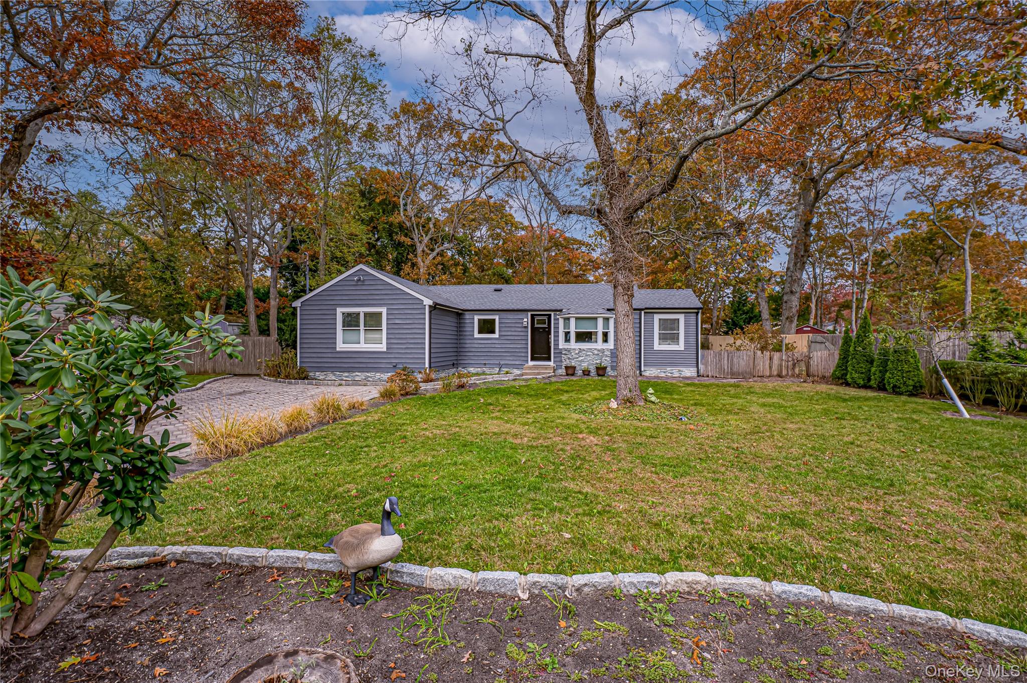 39 Lynncliff Road Hampton Bays, NY 11946 - Photo 3 of 34 View of front of house featuring view of scattered trees