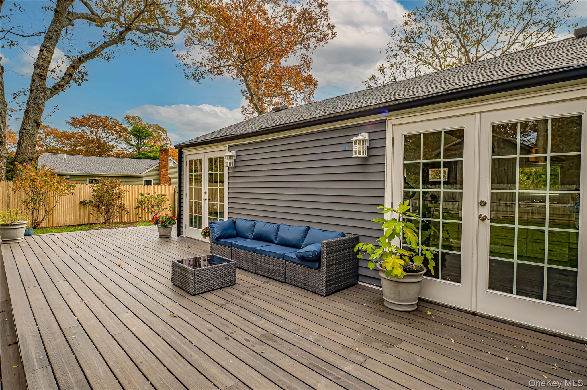 39 Lynncliff Road Hampton Bays, NY 11946 - Photo 30 of 34 Wooden terrace featuring french doors and outdoor lounge area