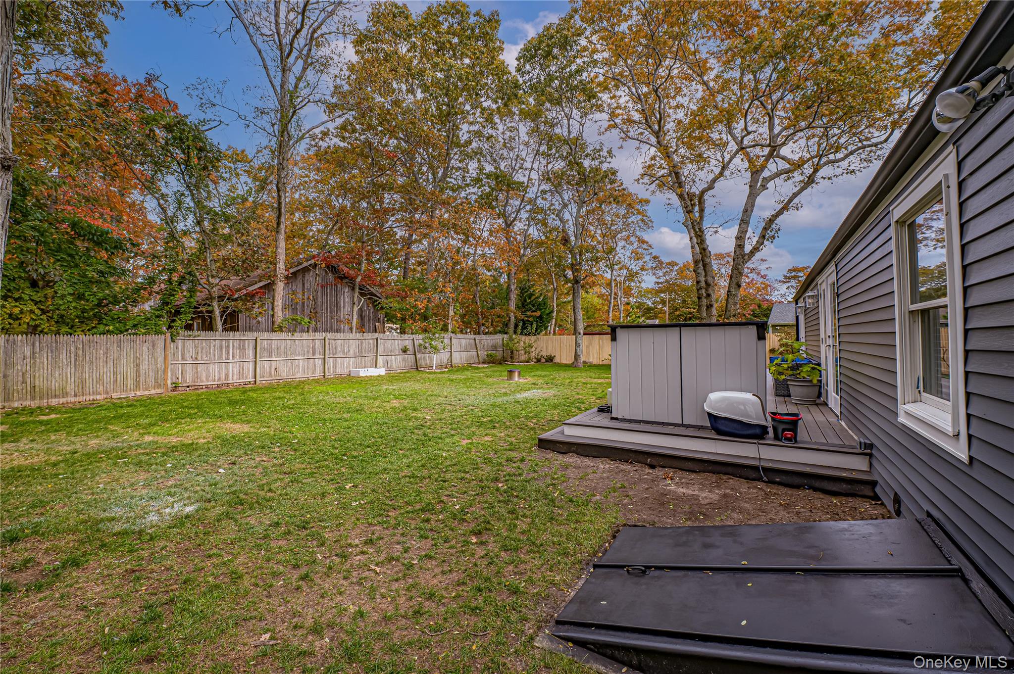 39 Lynncliff Road Hampton Bays, NY 11946 - Photo 31 of 34 Fenced backyard featuring a wooden deck