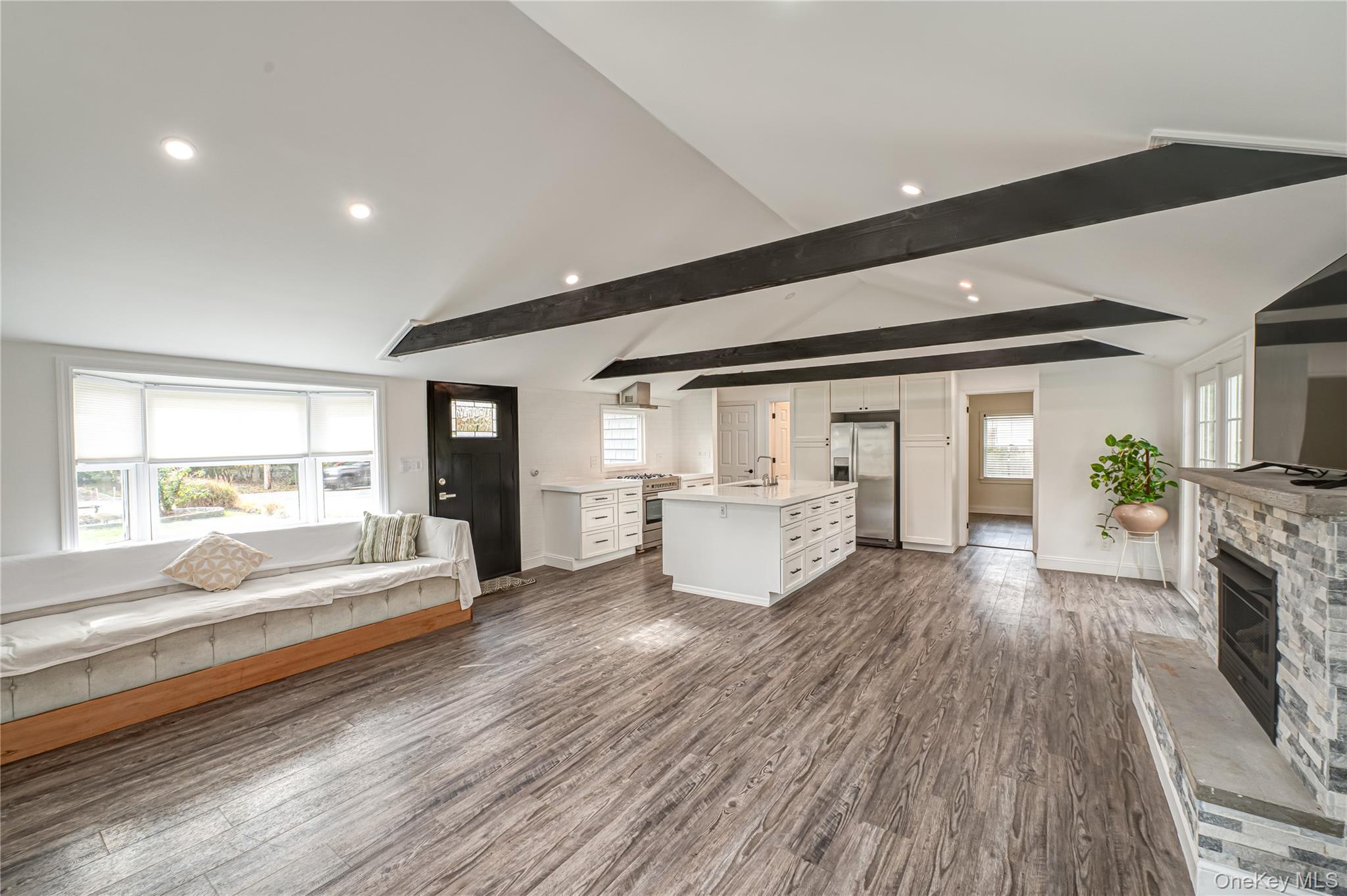 39 Lynncliff Road Hampton Bays, NY 11946 - Photo 5 of 34 Living room with dark wood-type flooring, a fireplace, and recessed lighting