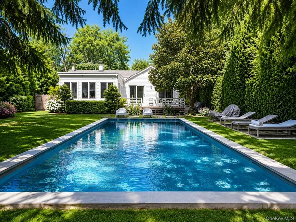 a view of a house with backyard porch and sitting area