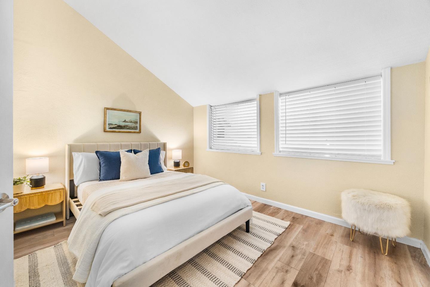 1644 Ocean Street Santa Cruz, CA 95060 - Photo 29 of 60 a bedroom with a bed and a chair with wooden floor