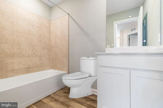 a bathroom with a toilet and a bathtub