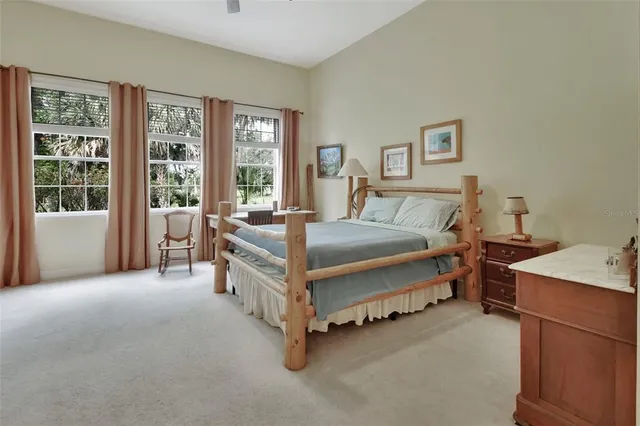 a spacious bedroom with a bed and a table in it