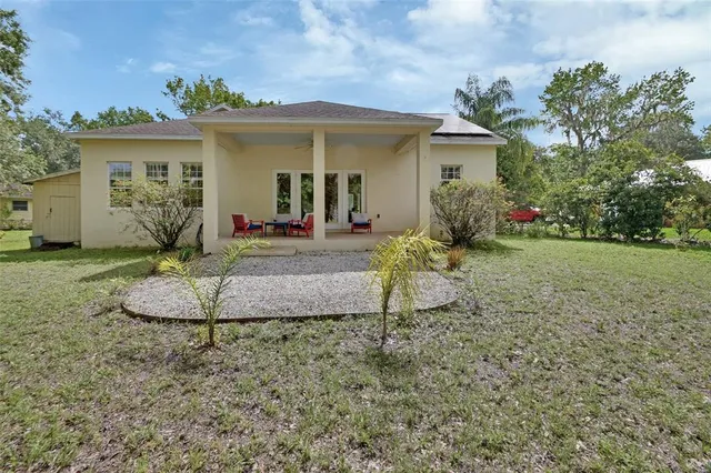 a view of a green field with trees