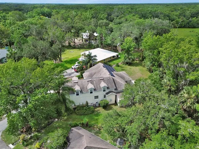 an aerial view of a house with outdoor space