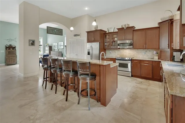 a large kitchen with cabinets table and chairs