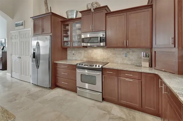 a kitchen with stainless steel appliances granite countertop a refrigerator sink and cabinets