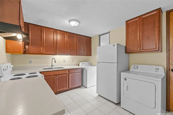 a kitchen with sink a refrigerator and cabinets