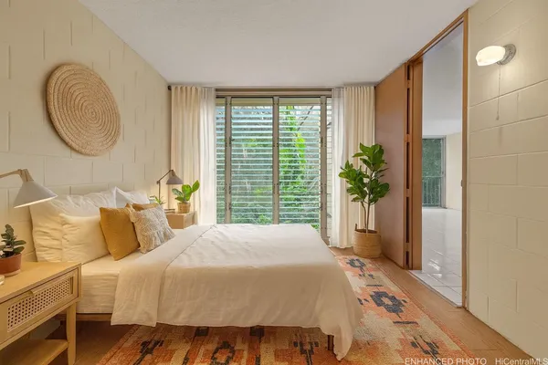 a bedroom with a bed and a mirror