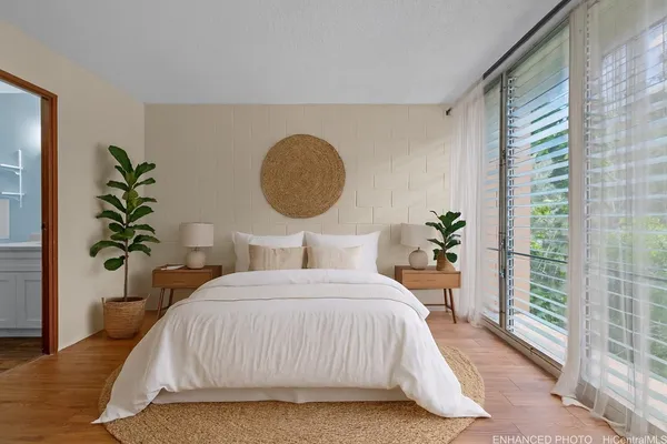 a bedroom with a bed and a potted plant