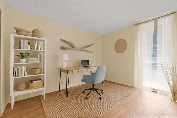 a workspace room with furniture and wooden floor