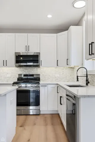 a kitchen with granite countertop a stove and a sink