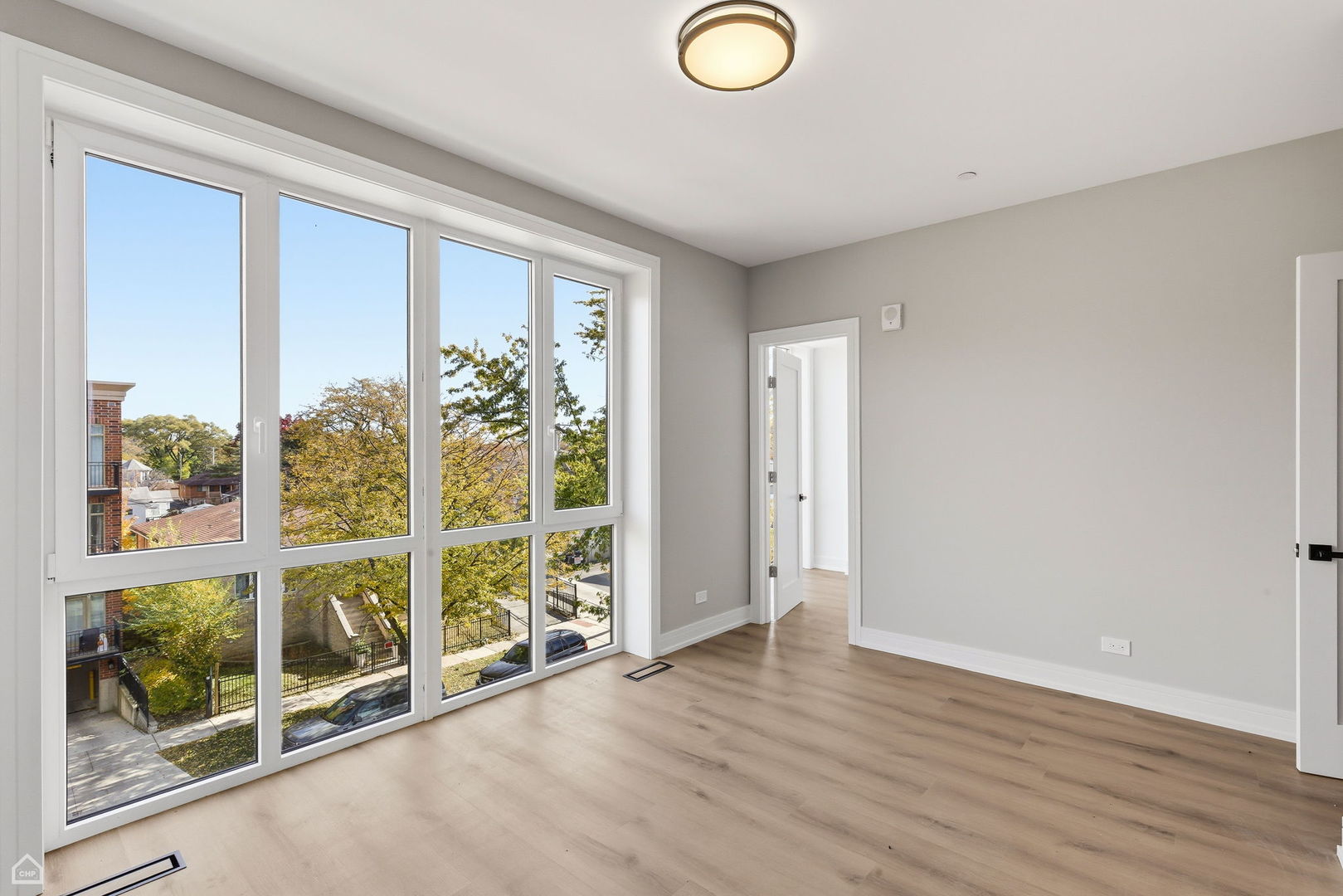 2718 Budd Street, Unit 2N River Grove, IL 60171 - Photo 17 of 48 an empty room with wooden floor and windows
