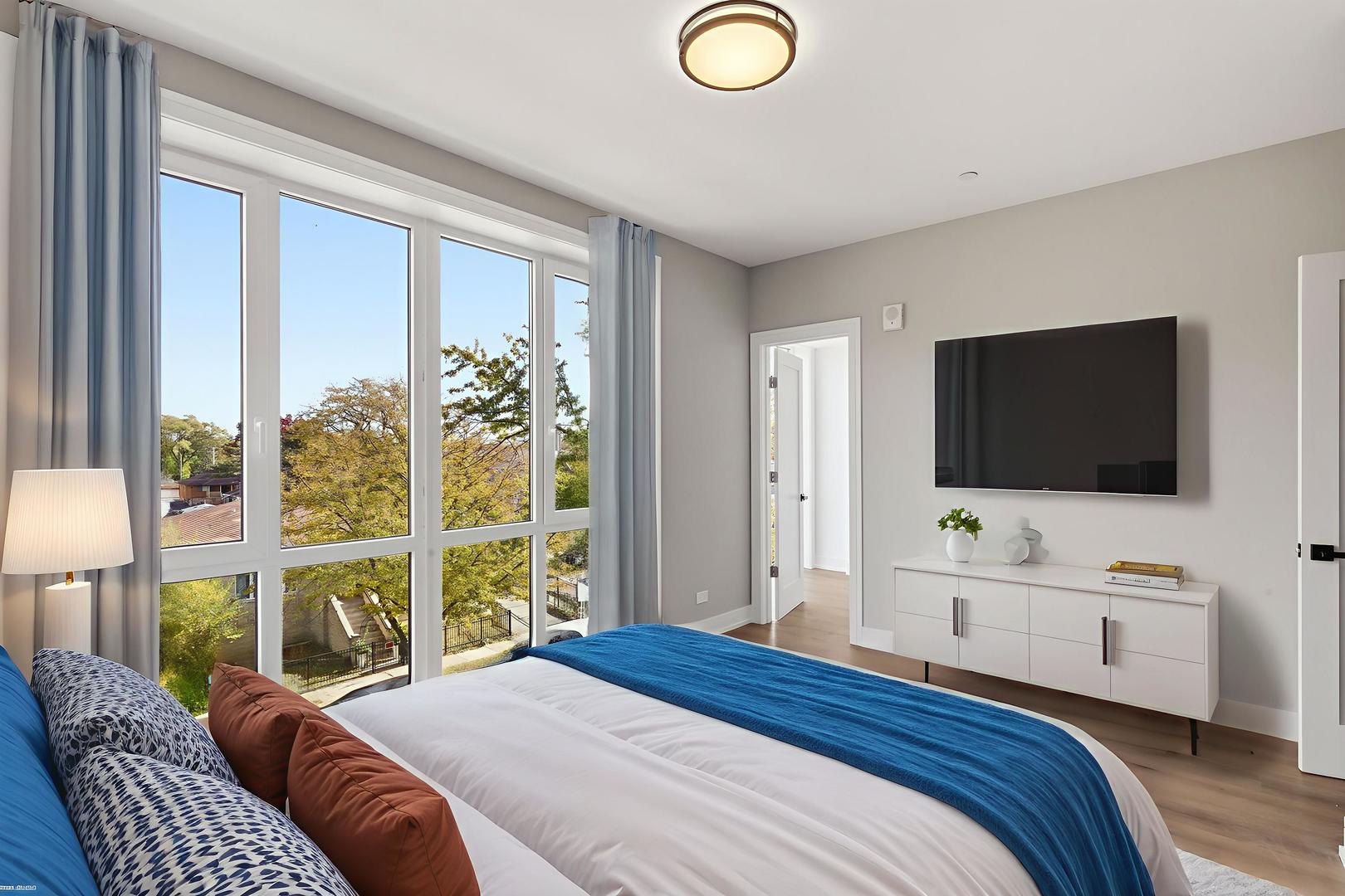 2718 Budd Street, Unit 2N River Grove, IL 60171 - Photo 18 of 48 a bedroom with a bed and a flat screen tv