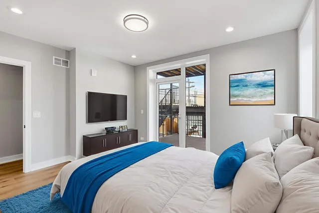 a bedroom with a bed and a flat screen tv