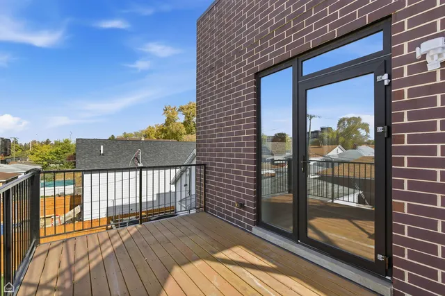 a view of a balcony with a barbeque