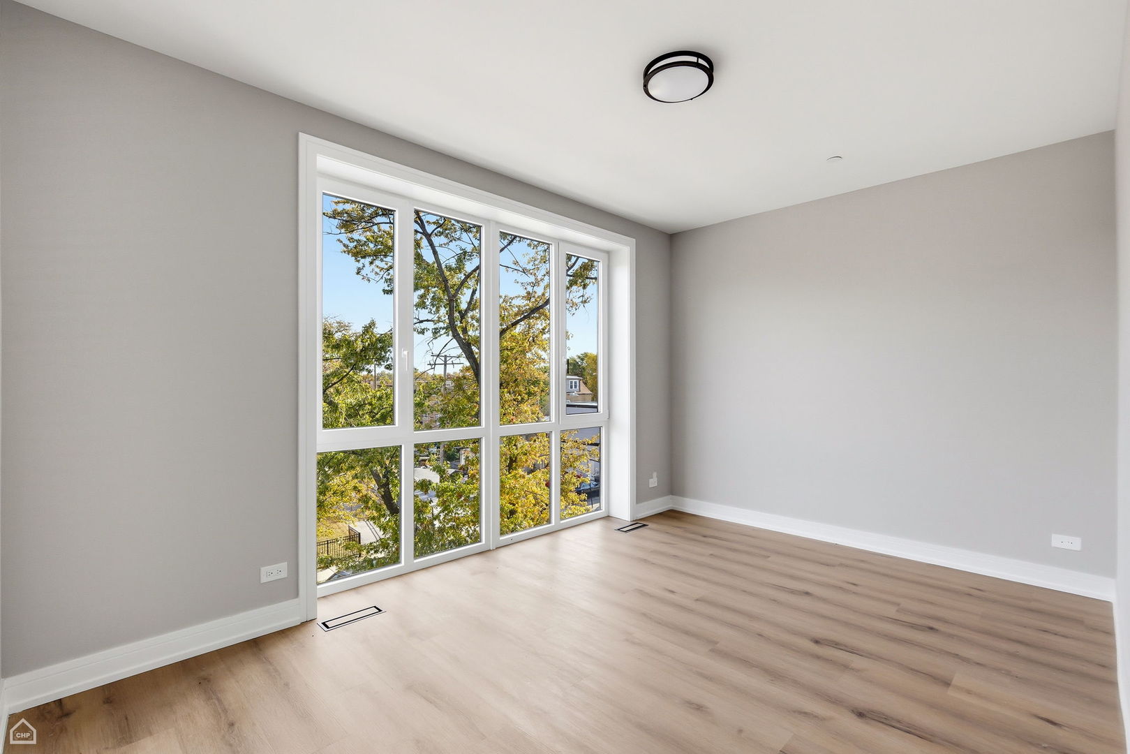 2718 Budd Street, Unit 2N River Grove, IL 60171 - Photo 32 of 48 an empty room with wooden floor and windows
