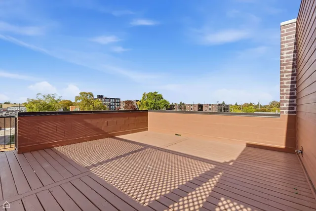 a view of roof deck with a lake view