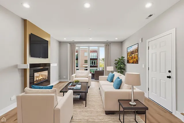a living room with furniture a fireplace and a flat screen tv